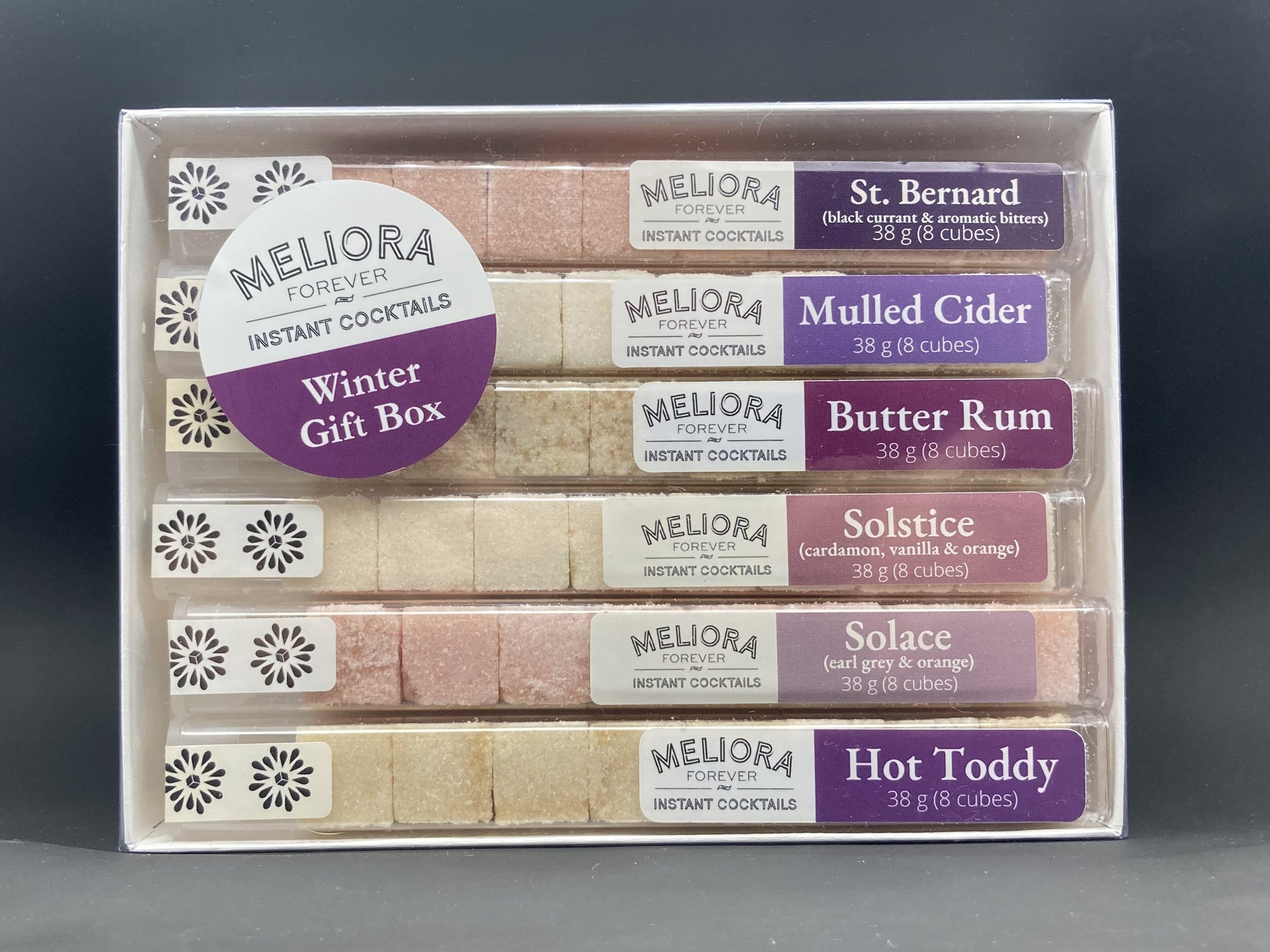 instant cocktail cubes, including 6 different flavors. Sugar cubes infused with bitters, fruits, and natural flavors. Each flavor is packaged in an 8-count tube. Flavors include St Bernard (Black Currant, Aromatic Bitters), Solstice (Cardamom, Vanilla, Orange), Mulled Cider, Butter Rum, Solace and Hot Toddy.