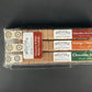instant cocktail cubes, which are cane sugar cubes infused with bitters, fruits, and natural flavors. There are three packages shown, including 8-count tubes of Chocolate Strawberry, Orange Chocolate and Chocolate Mint.