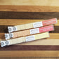 instant cocktail cubes, which are cane sugar cubes infused with bitters, fruits, and natural flavors. There are three packages shown, including 8-count tubes of Passion Orange Blossom, Cherry Rose Calamansi, and Elderflower and Yuzu. 